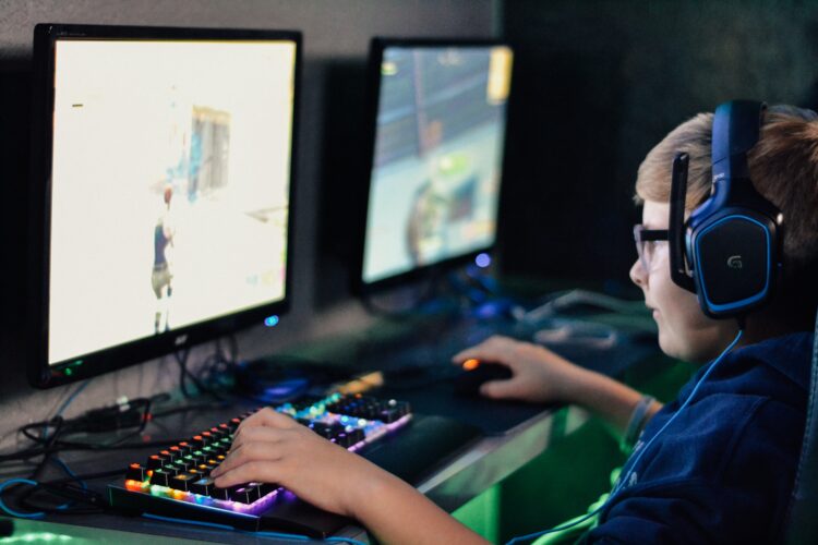 boy wearing headset playing computer game