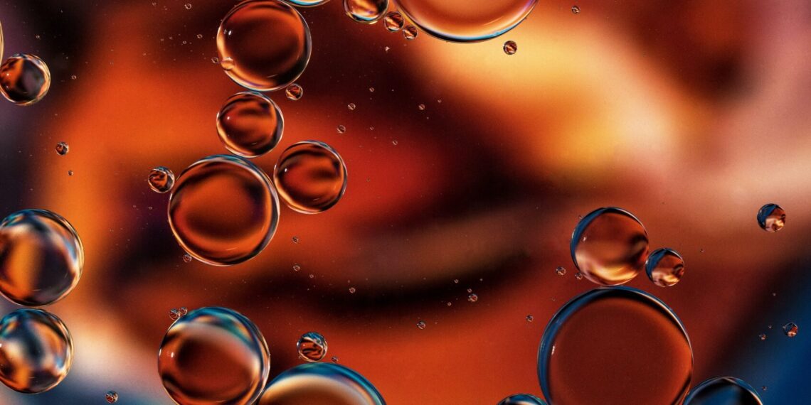 "Resplandor de cobre". Gotas de aceite sobre el agua. El fondo es una fotocopia A3 de una de las fantásticas fotografías del fotógrafo de Unsplash, Vinicius Amano. Consulte el tutorial en la página "Fotografía de agua y aceite" en mi sitio Tracts4free.WordPress.com.