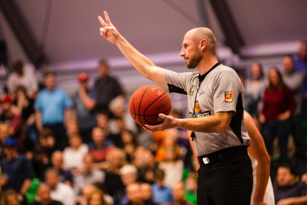shallow focus photo of man holding basketball