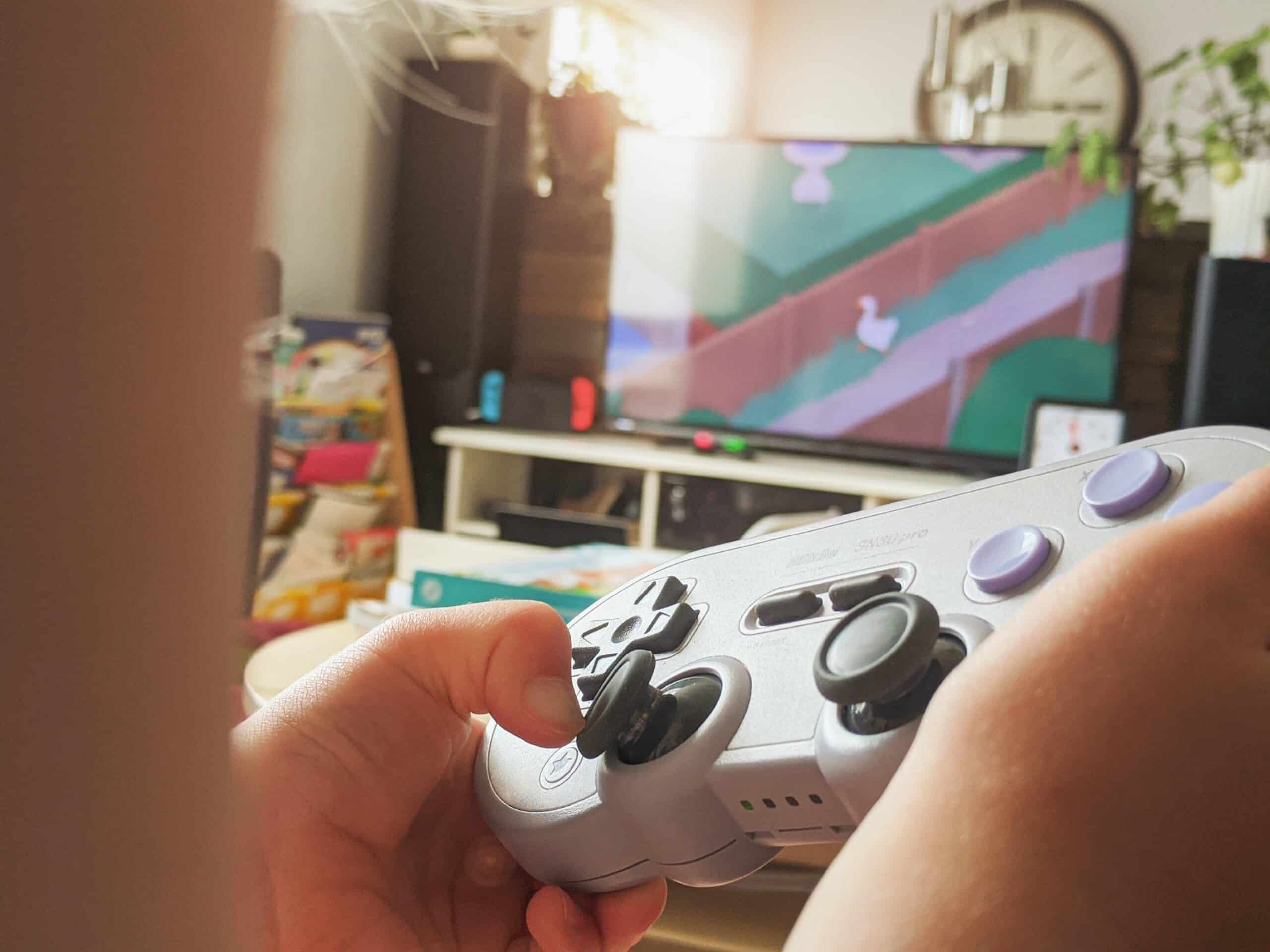 person holding black and white xbox one game controller