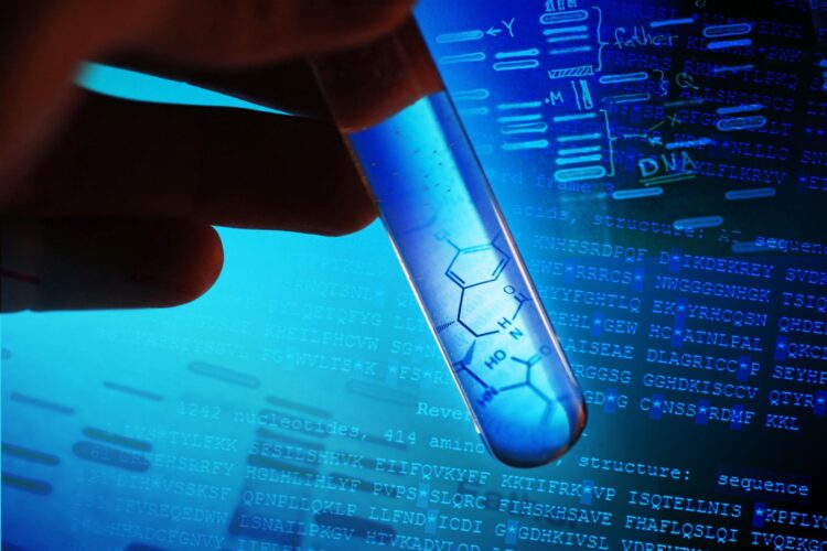 A test tube with blue liquid and a graphic of a partial molecule.  There is a hand holding the test tube against a computer image of sequenced DNA.  The image is highlighted in dark and light blue.  This is a macro image with selective focus.