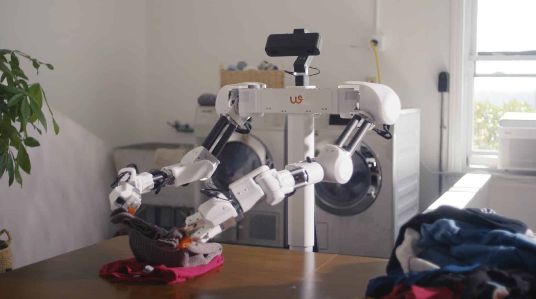 robot domestico pila vestiti piegati su tavolo in appartamento