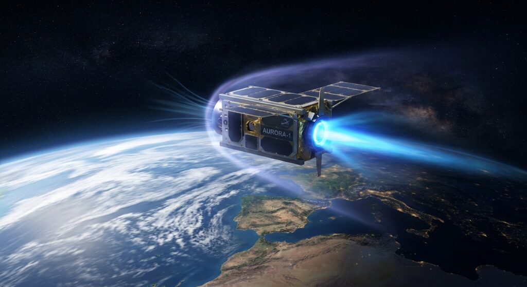 A small sleek microsatellite orbiting Earth at extremely low altitude, approximately 200 kilometers above the planet's surface, surrounded by a faint wisp of rarefied upper atmosphere rendered as a delicate blue-violet glow. The satellite features a glowing plasma thruster chamber emitting a vivid electric blue exhaust plume, visually suggesting it is drawing in thin atmospheric molecules and expelling them as propulsion. Below, the curvature of Earth is visible with cloud formations and continental outlines. The surrounding space is dark and star-filled. The visual style is a detailed, cinematic scientific illustration with a dramatic contrast between the warmth of Earth's atmosphere below and the cold void of space above, rendered in a photorealistic digital art style with volumetric lighting and a sense of technological elegance and innovation.